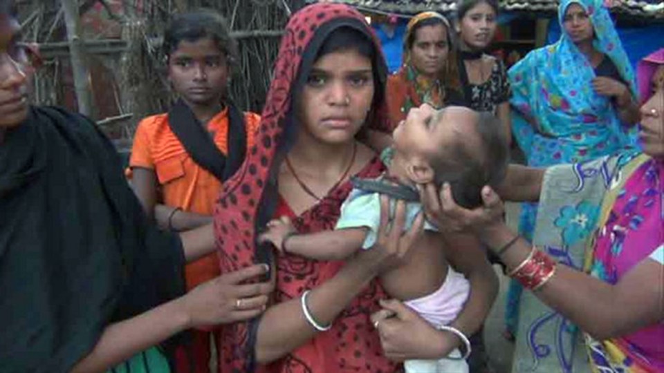  Devastated . . . Sandeep's wife holding their child