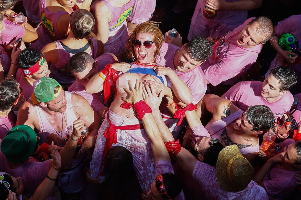  Handymen: A woman lays back and allows men to grope her at the start of the nine-day bull-running festival