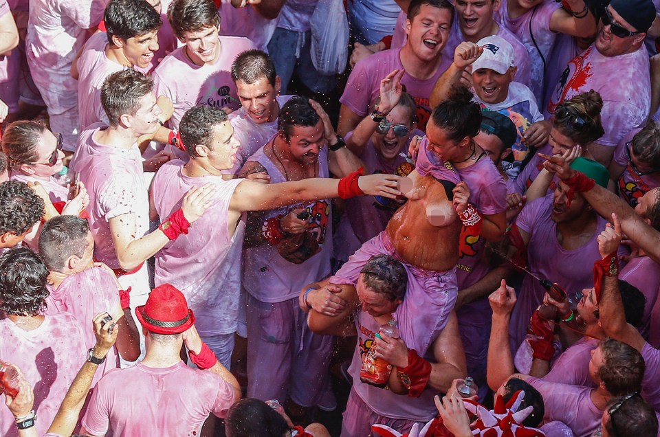  The breast in town: A woman allows a man to touch her boob because it's the start of a festival in Spain