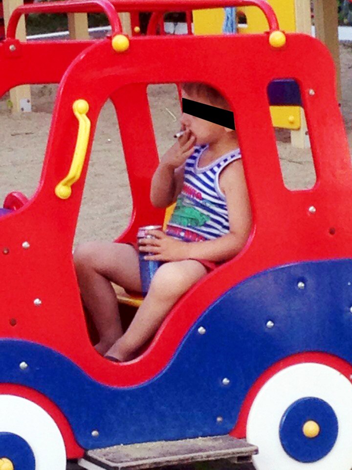  Smoking... child of around 4 or 5 is snapped with a cigarette and what appears to be a can of beer