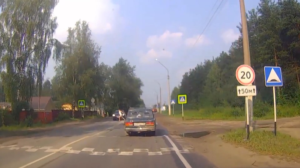  The woman is walking across the road using a zebra crossing when she realises the car coming towards her is not slowing down