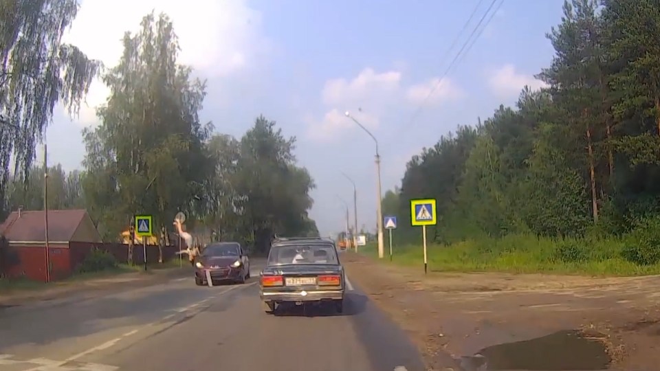  She is flipped into the air and her body inverts with the impact of the car as the car's numberplate is also seen to be coming off