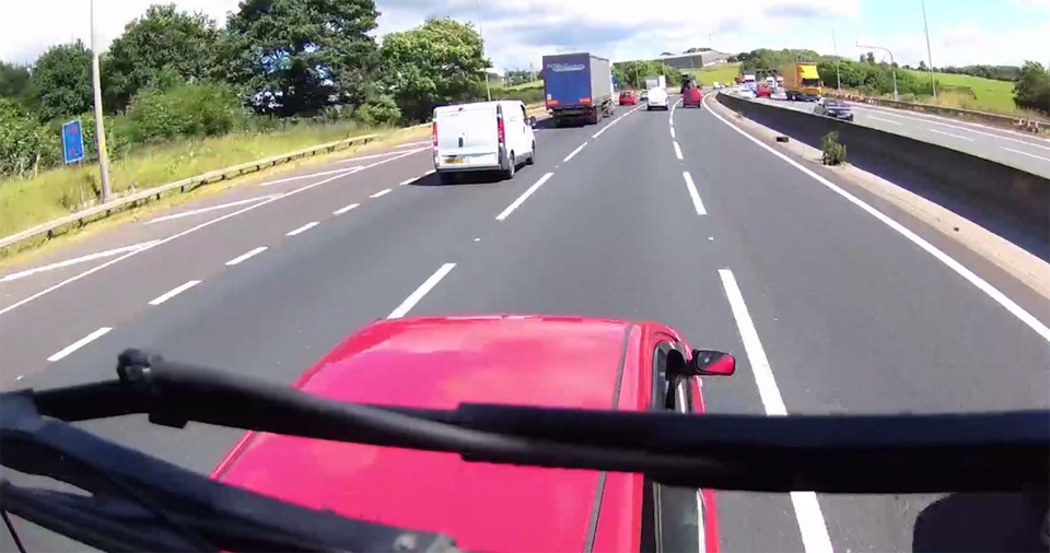  The 44-tonne lorry crashes into the back of the car as the pair begin to battle it out in the middle lane of the motorway