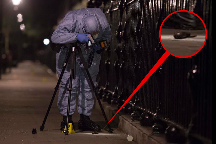  A forensic officer examines what is believed to be the knife used in the attack