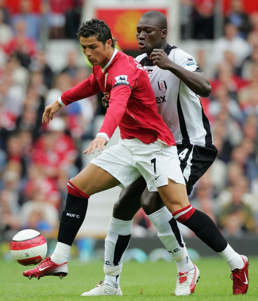 MANCHESTER, ENGLAND - AUGUST 20: Cristiano Ronaldo of Manchester United clashes with Papa Bouba Diop of Fulham during the Barclays Premiership match between Manchester United and Fulham at Old Trafford on August 20 2006 in Manchester, England. (Photo by John Peters/Manchester United via Getty Images)