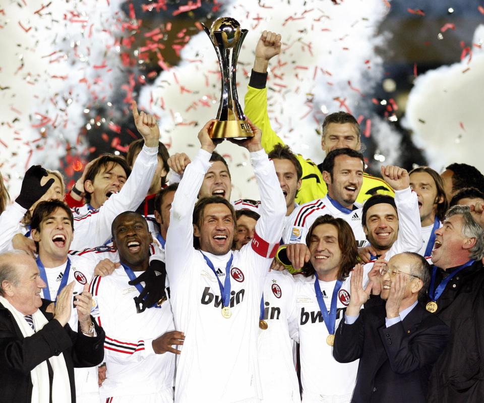 AC Milan captain Paolo Maldini (C) raises the trophy with his teammates following the final match of the FIFA Club World Cup in Yokohama, 16 December 2007. AC Milan defeated Boca Juniors 4-2. AFP PHOTO / KEN SHIMIZU (Photo credit should read KEN SHIMIZU/AFP/Getty Images)