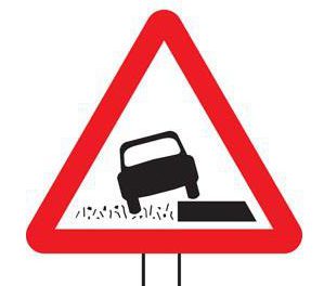  The lopsided car tells drivers that the road's verges are softer than the road surface up ahead. A plate under the sign will inform drivers of the distance this applies for