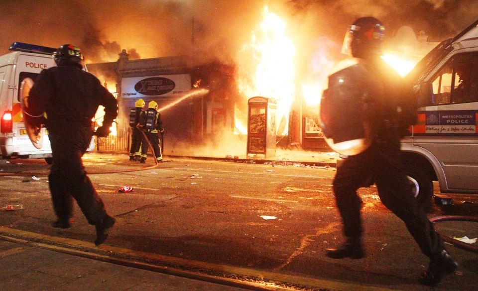  Riot police patrol the streets in Tottenham, north London as trouble flared after members of the community took to the streets