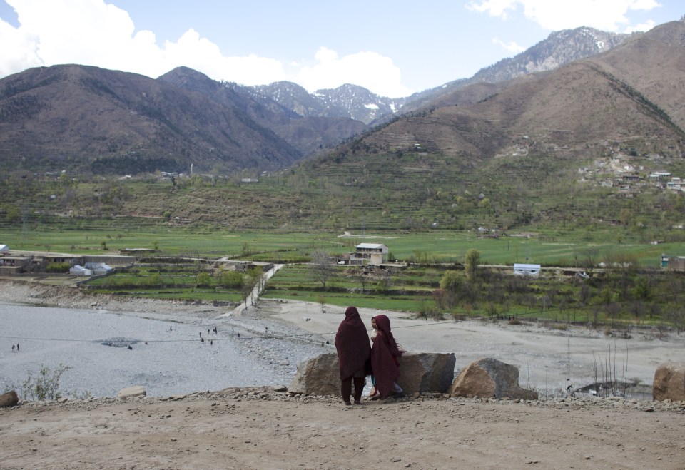  Young girls in headscarves look out over Swat Valley, where a man and woman were stoned (stock image)