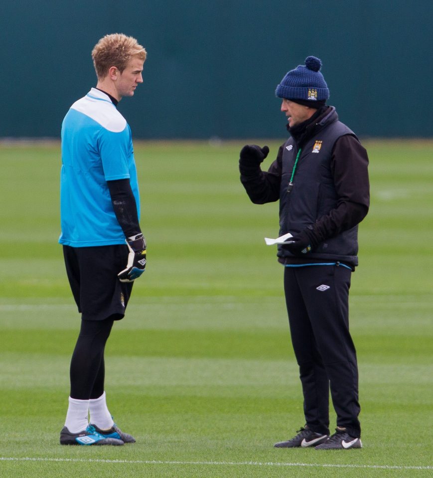 Joe Hart speaks with Roberto Mancini at training back in 2012