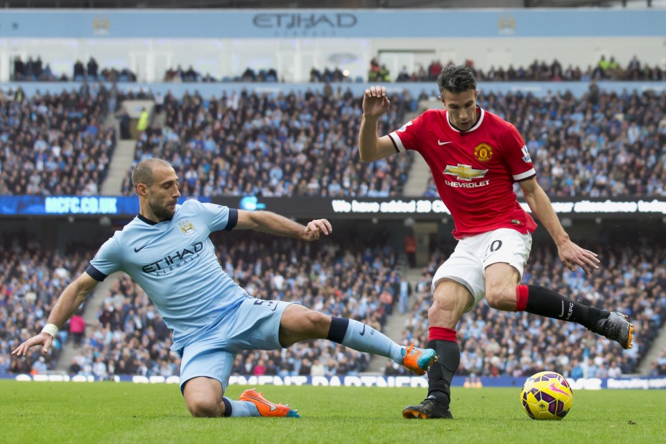  Zabaleta fights for the ball against Manchester United's Robin van Persie during their Premier League match at the Etihad