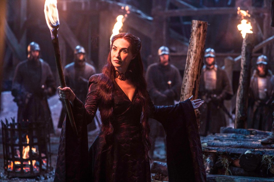  Melisandre clutches a flaming torch in a scene from Game Of Thrones