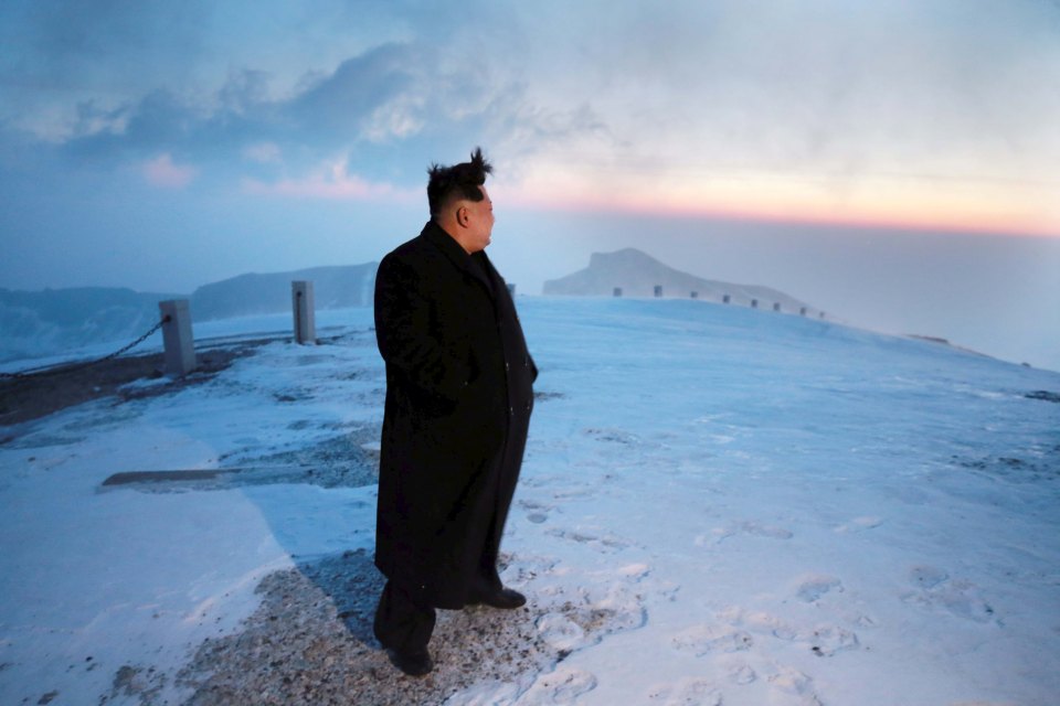  North Korean leader Kim Jong Un views the dawn from the summit of Mt Paektu with warnings his nuclear tests could be making the volcano more likely to erupt