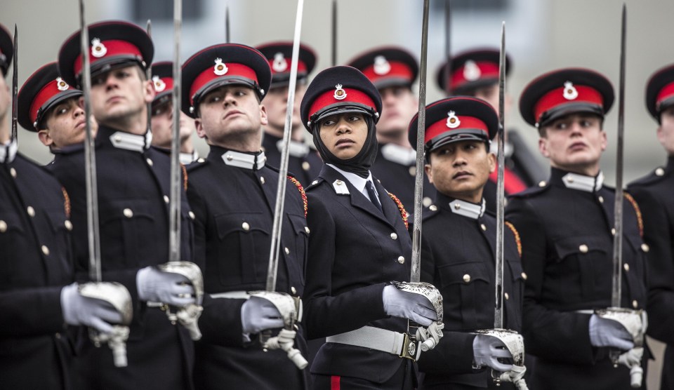  A graduating female officer wears traditional muslim headress as she marches on parade at sandhurst military academy