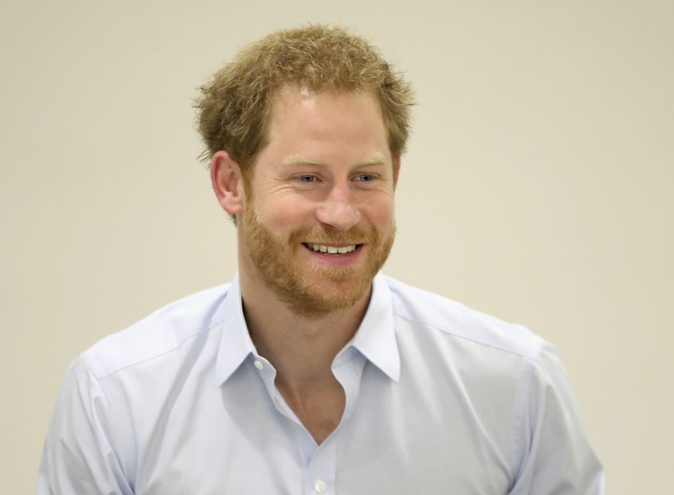 Prince Harry chats with staff during his visit to the Burrell Street Sexual Health Clinic in London