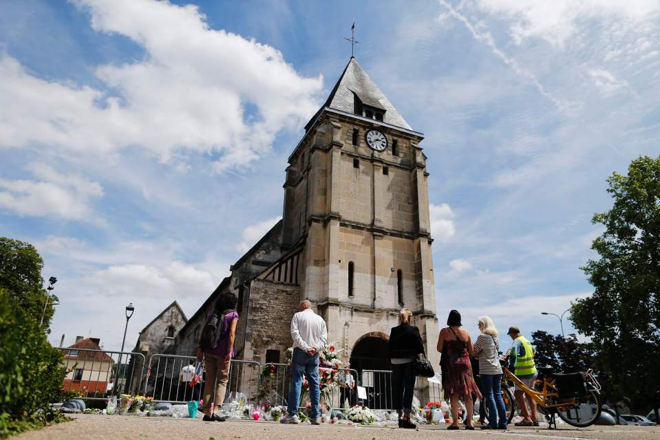  Memorial... people gather to lay tributes in front of the church of Saint-Etienne-du-Rouvray where French priest Jacques Hamel was killed