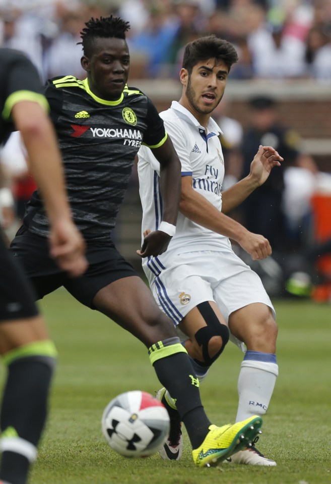 Real Madrid midfielder Marco Asensio Willemsen (R) passes the ball past Chelsea midfielder Bertrand Traore (L) during an International Champions Cup soccer match in Ann Arbor, Michigan on July 30, 2016. / AFP PHOTO / Jay LaPreteJAY LAPRETE/AFP/Getty Images