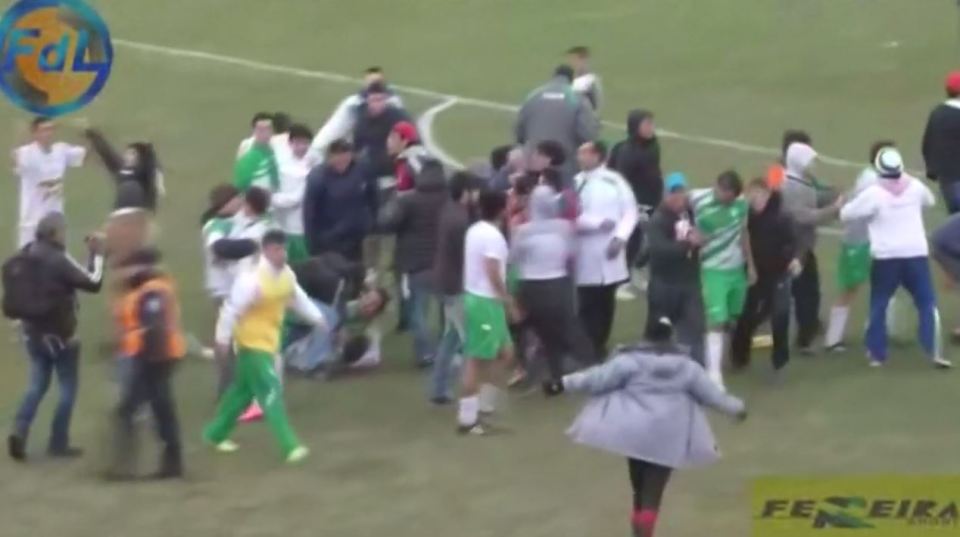  Bella Vista fans storm onto the pitch after their 3-2 win over Tiro