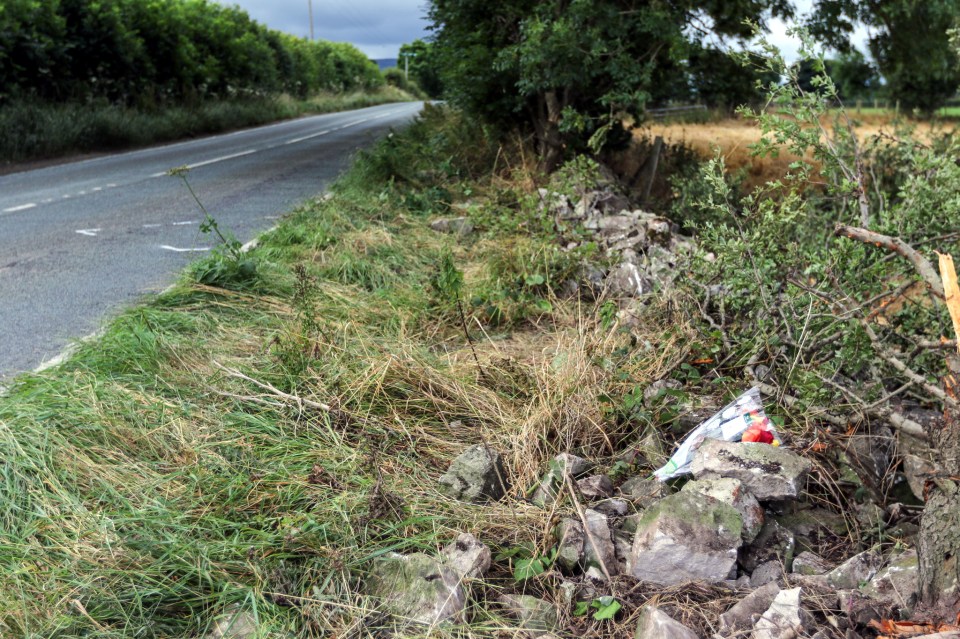  A floral tribute lies at the scene of the impact as evil Draper's parents hailed him