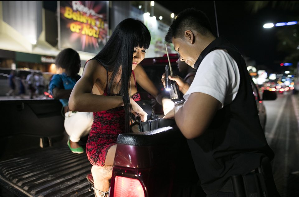  A Thai ladyboy is checked by police after being arrested