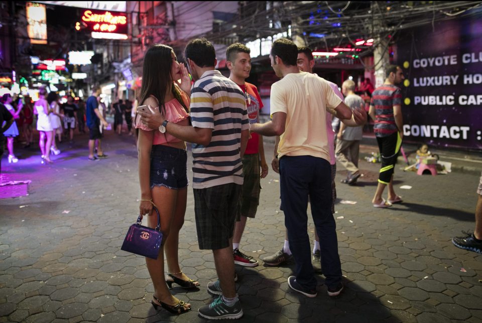  A bar girl negotiates a price with men for her services