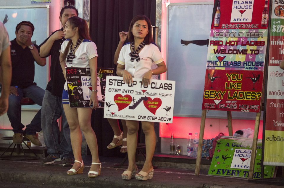  Bar girls hold signs to attract customers inside