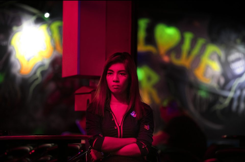  A Thai woman waits for her next customer at a go-go bar