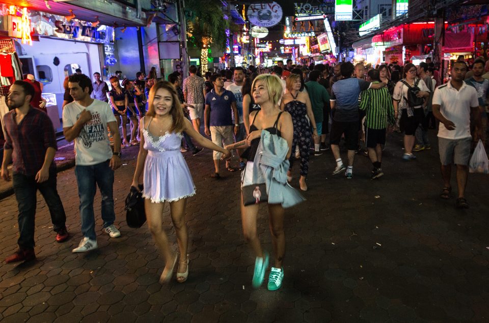  Women walk along Walking Street where bars and sex scenes are commonplace