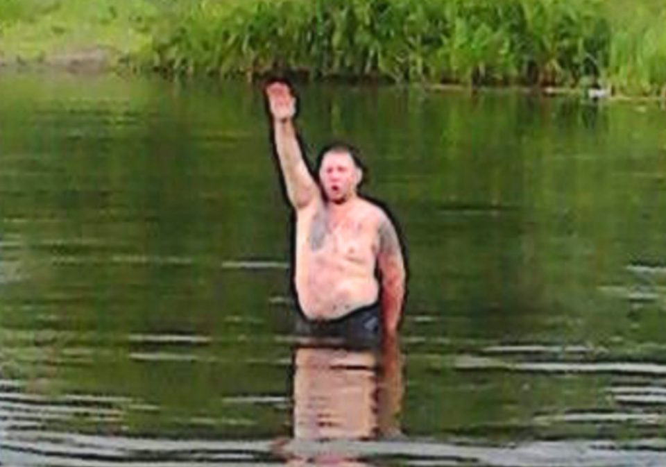  Sick... Barbaric cabbie Sergey Sokolov performs a Nazi salute in the middle of a lake. He has admitted to beheading Kristina Medvedeva on their first date