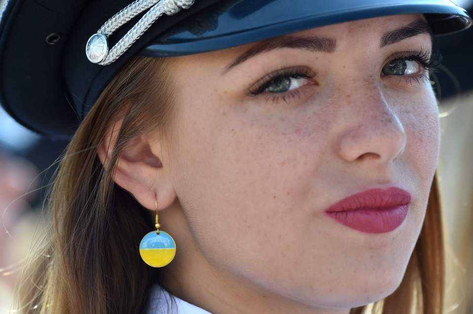  A female member of the police wearing national flag earrings in a show of patriotism