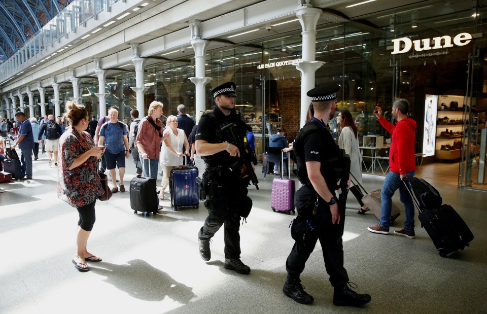  Armed cops patrolled St Pancras in twos as commuters went about their daily lives