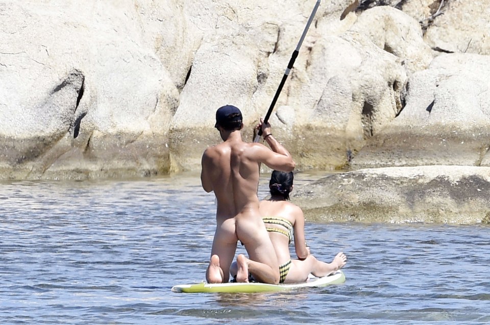  Katy sat happily while the naked hunk paddled them about