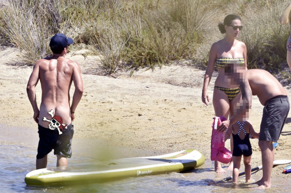  He quickly pulled up his shorts as other holiday makers stood by