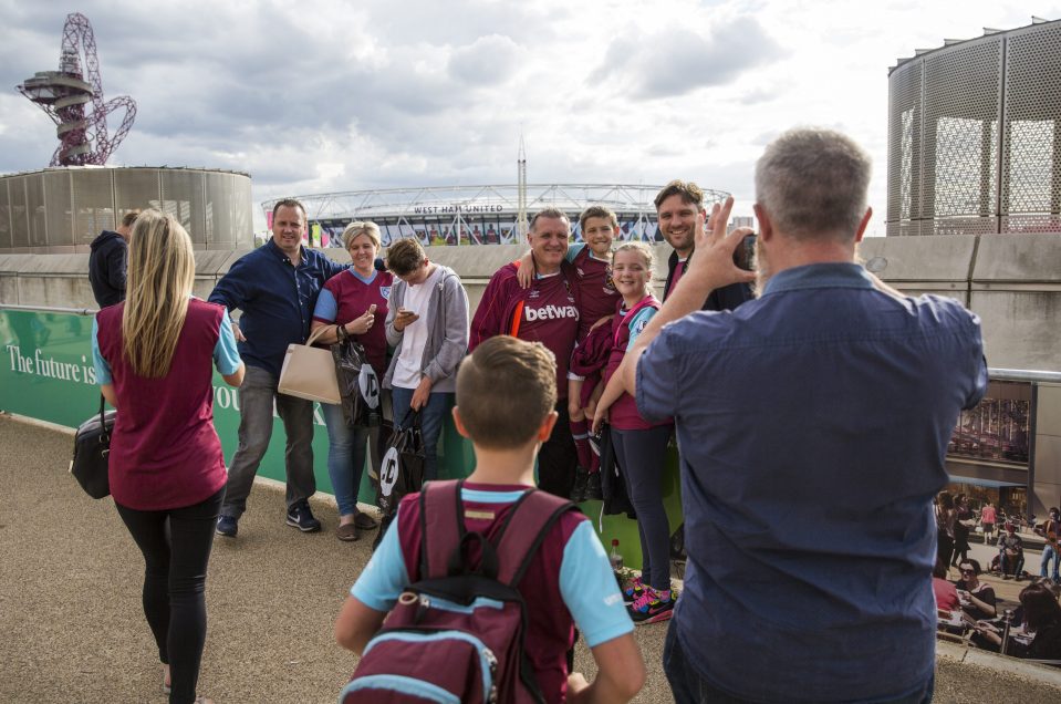  Fans pose for a picture ahead of kick-off with the Olympic Stadium in the distance