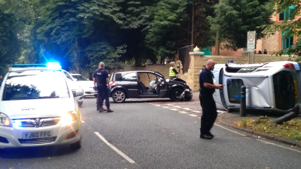  The overturned motorist's car is seen next to the dealers' stolen Renault