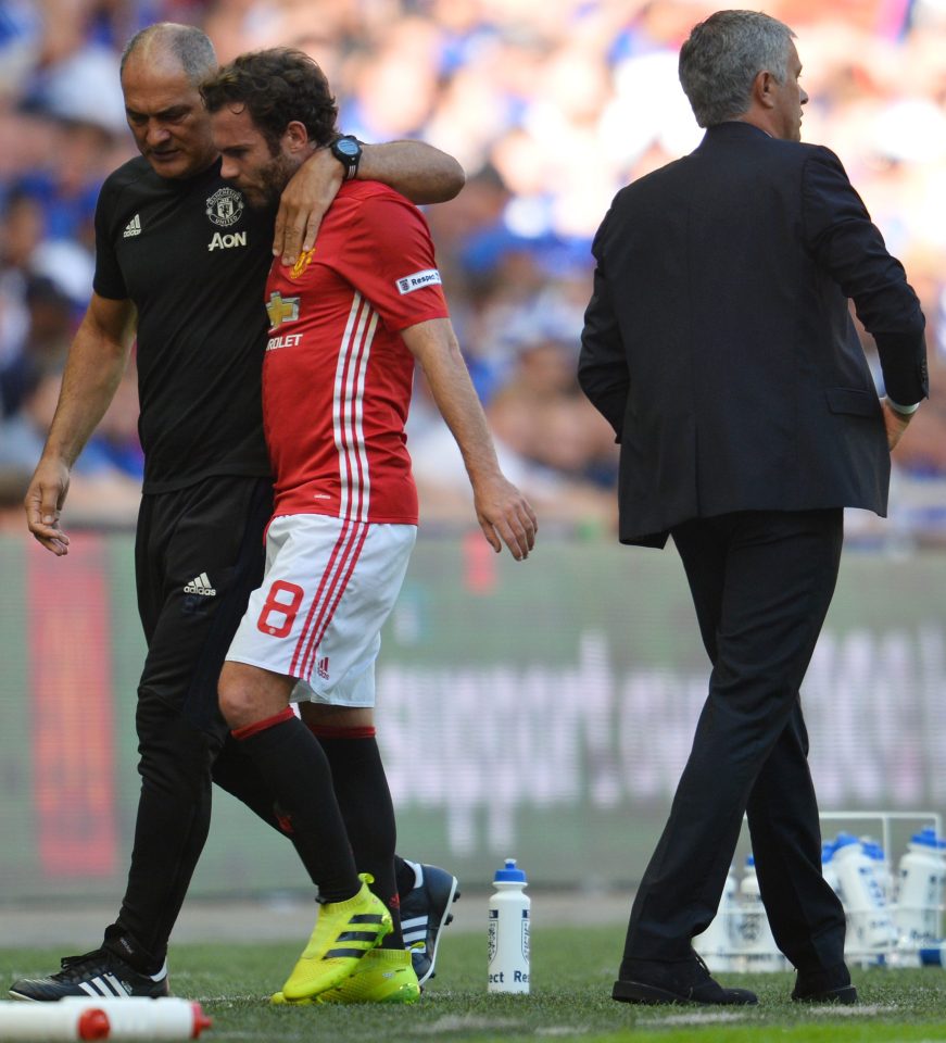  FIrst team coach Silvino Louro leads Mata back to the bench as Manchester United manager Jose Mourinho breezes past after making his controversial decision