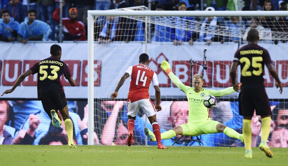  Theo Walcott lifted the ball over Joe Hart to score Arsenal's second