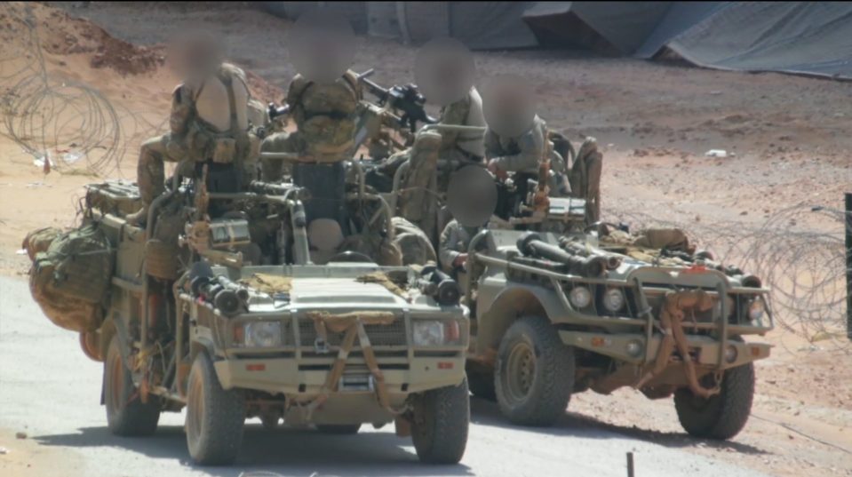  Soldiers belonging to the British Special Forces sit on their patrol vehicles inside Syria