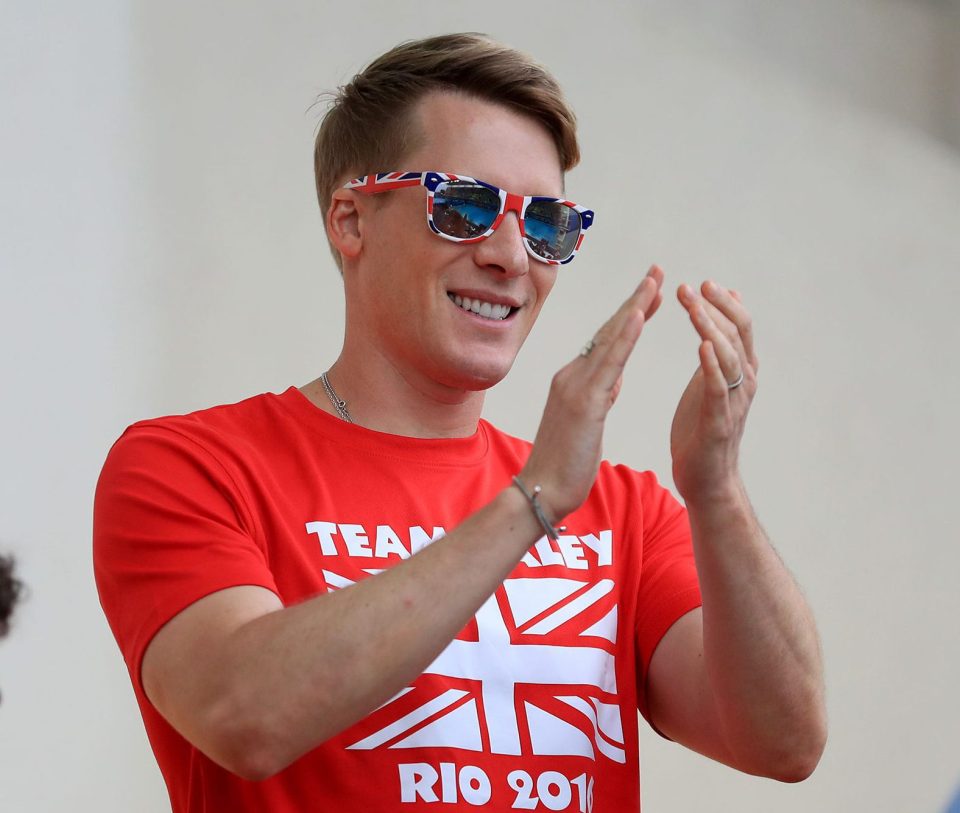 Daley's partner Dustin Lance Black shows his support in the stands at the Maria Lenk Aquatics Centre