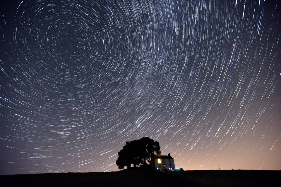  A lone farmhouse stands under the backdrop of a 'rotating' night sky during the early hours of this morning