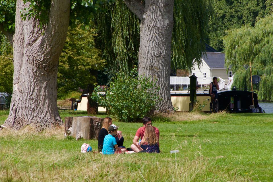  A family enjoy a picnic by the river as UK braces itself some glorious heat in the coming days