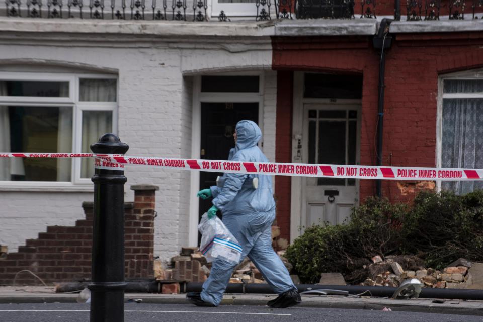  Forensic officers collect evidence from the crime scene on Wandsworth Bridge Road