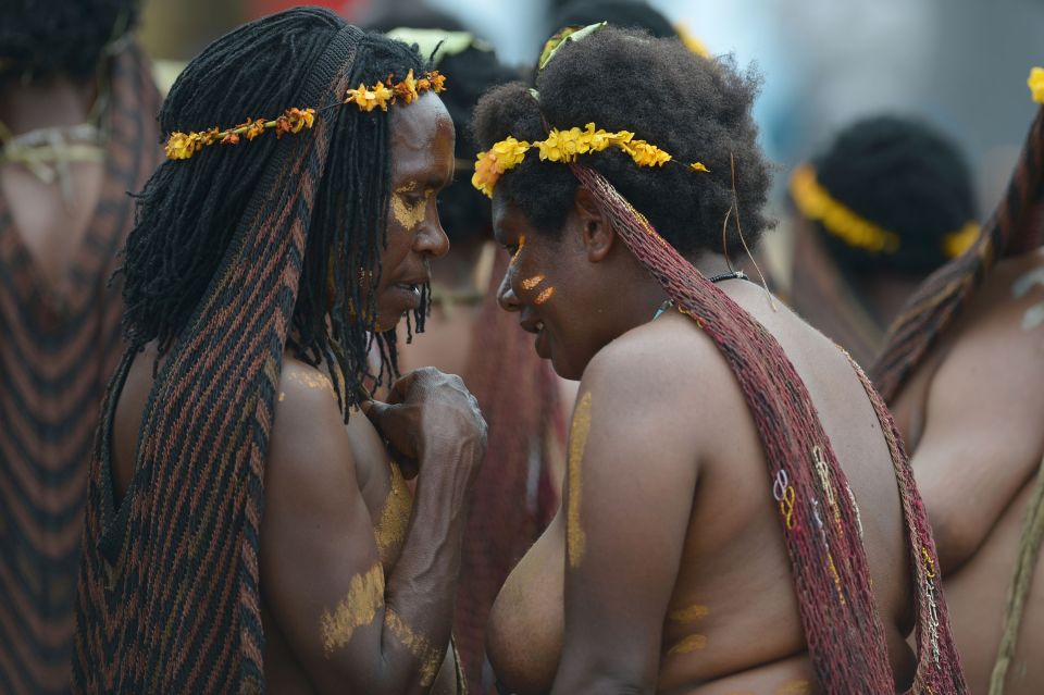  Women of the tribe wear skirts made from woven orchid fibres and decorated with straw