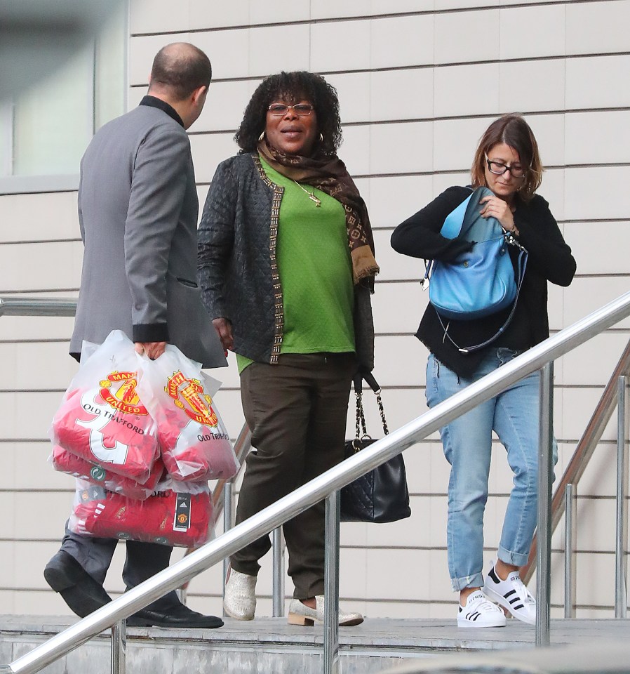  Paul Pogba's mum with several bags containing her son's No.6 shirts