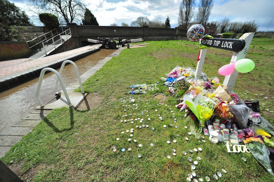  Floral tributes and balloons have been placed near the spot where Sean fell in the water and drowned