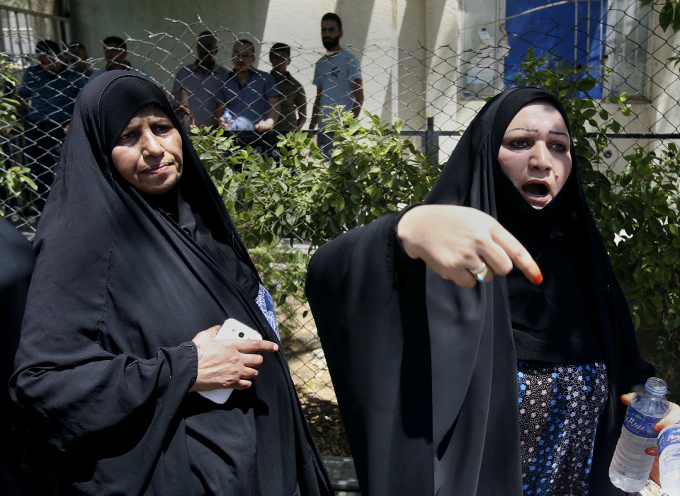  Two women protest outside the hospital in western Baghdad