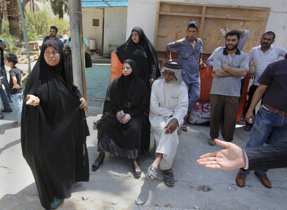  Relatives of those killed in the blaze gathered outside the building today