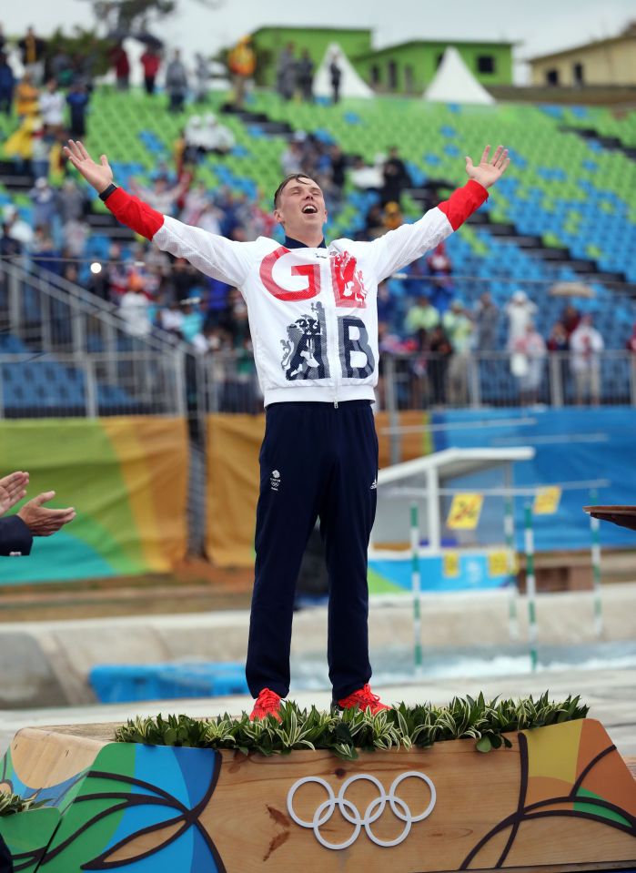  Joe Clarke opens his arms on the top of the podium after winning gold for Team GB