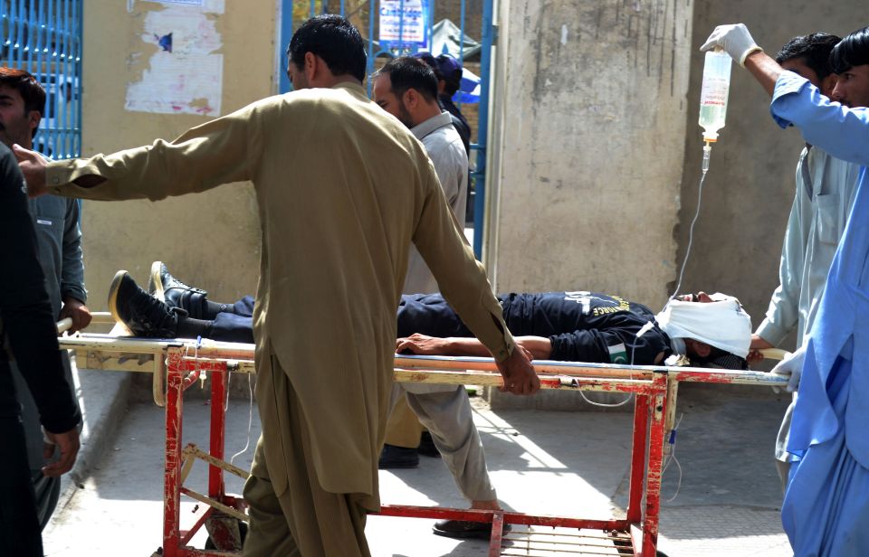  An injured policeman, one of the more than 13 injured in the attack, is taken away from the scene