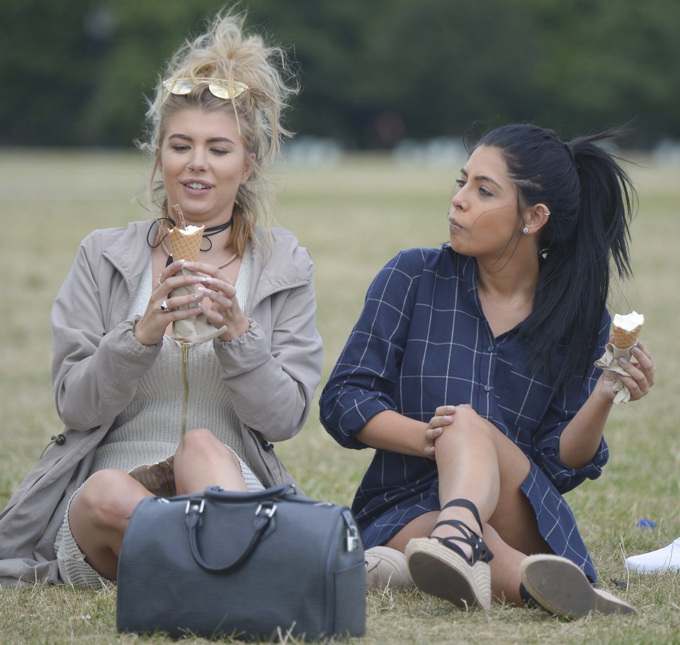  The girls catch up on the grass as they enjoy a day in the park